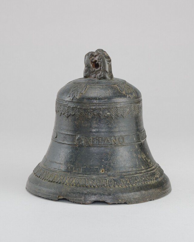 Bronze hand bell by Gaetano Albertazi with a band of lettering around its body.