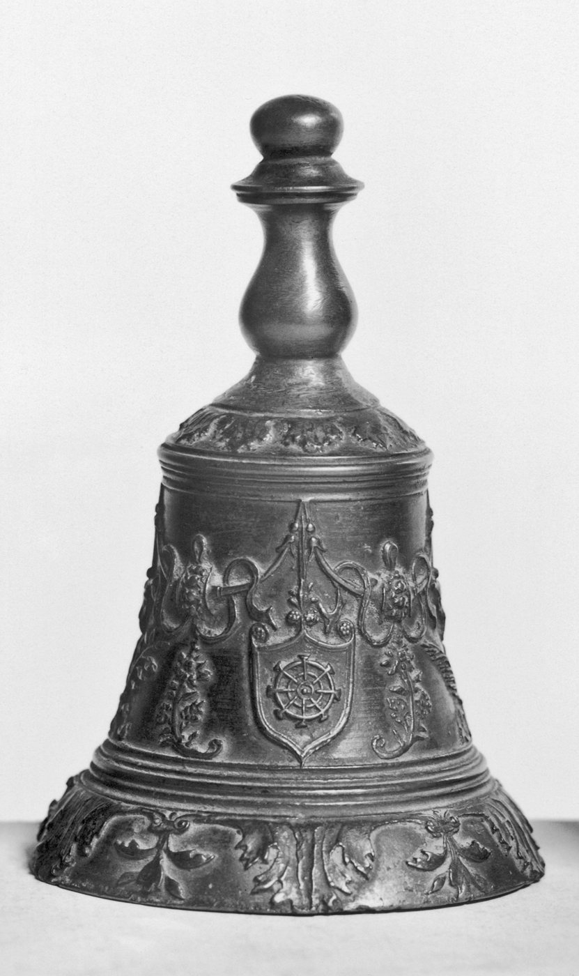 Decorated bronze hand bell bearing two heraldic shields.
