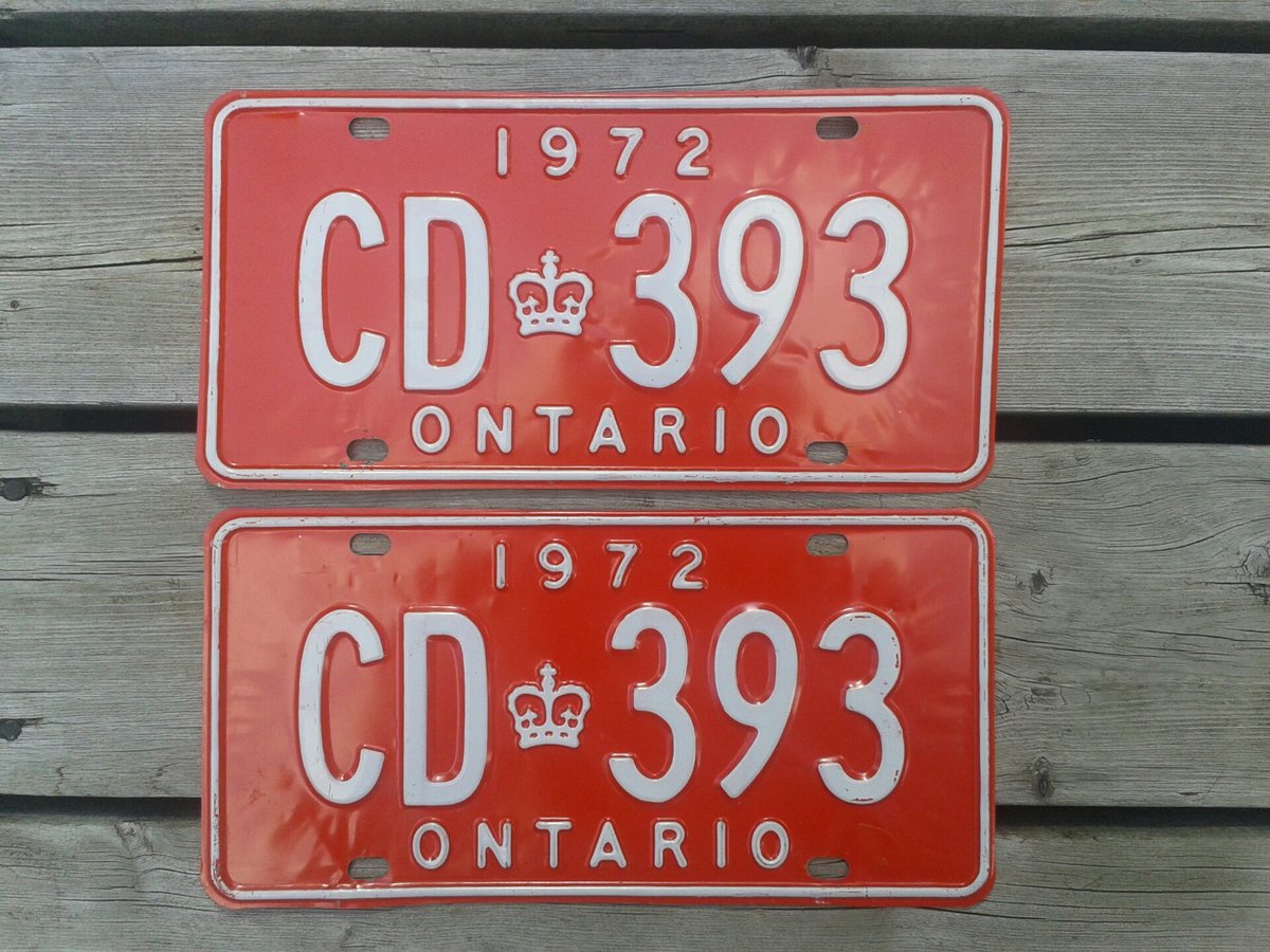 Two red and white 1972 Ontario diplomatic plates with matching CD-393 numbers, photographed together
