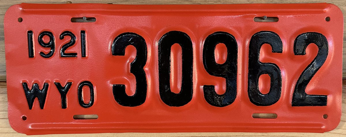 Red and black Wyoming licence plate dated 1921 and numbered 30962, documented as repainted